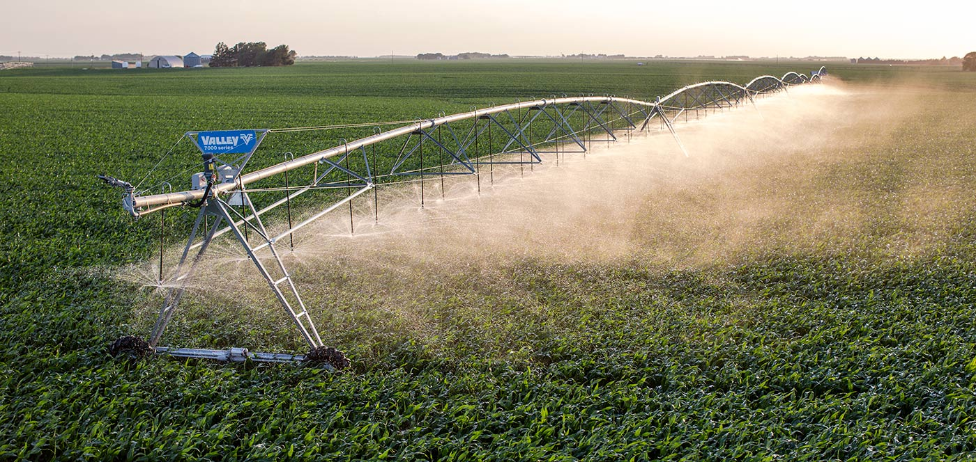 Valley 7000 series pivot spraying a wide pattern across a lush green field